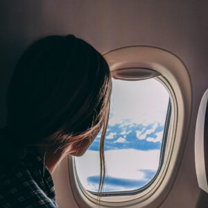person holding smartphone riding airplane